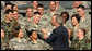President George W. Bush greets military personnel on stage Monday, Aug. 4, 2008, at Eielson Air Force Base during a stop in Alaska en route to South Korea. White House photo by Chris Greenberg