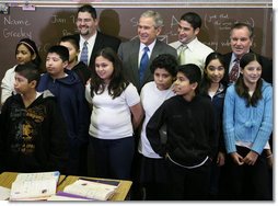 President George W. Bush is joined by Principal Carlos Azcoitia, left; teacher Rene Camler and Chicago Mayor Richard M. Daley, right, Monday, Jan. 7, 2008, during a visit with students and staff at the Horace Greeley Elementary School in Chicago. White House photo by Joyce N. Boghosian