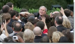 President George W. Bush reaches out to staff members of the Executive Office of the President Thursday, Nov. 6, 2008, after speaking to them on the upcoming presidential transition. The President was joined by his Cabinet, Vice President and Mrs. Cheney and Mrs. Laura Bush as he told his staff, "As January 20th draws near, some of you may be anxious about finding a new job, or a new place to live. But between now and then, we must keep our attention on the task at hand -- because the American people expect no less."  White House photo by Joyce N. Boghosian