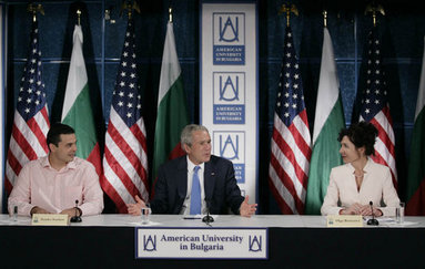 President George W. Bush gestures as he addresses a roundtable on free-market democracy at the American University in Sofia, Bulgaria, Monday, June 11, 2007, joined by Stanko Stankov, left, and Olga Borissova, the director of American University in Bulgaria Center. White House photo by Eric Draper White House photo by Eric Draper