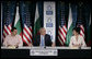 President George W. Bush gestures as he addresses a roundtable on free-market democracy at the American University in Sofia, Bulgaria, Monday, June 11, 2007, joined by Stanko Stankov, left, and Olga Borissova, the director of American University in Bulgaria Center. White House photo by Eric Draper