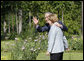 President George W. Bush waves as he walks with German Chancellor Angela Merkel Wednesday, June 11, 2008, during his visit with the fellow leader at Schloss Meseberg, Germany. White House photo by Eric Draper