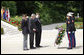 President George W. Bush is flanked by two U.S. World War II Veterans during wreath-laying ceremonies Saturday, June 14, 2008, at the Suresnes American Cemetery and Memorial in Suresnes. White House photo by Eric Draper