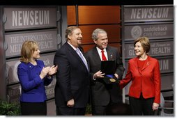 President George W. Bush, joined by Mrs. Laura Bush, is presented with the International Medal of PEACE by Pastor Rick Warren and his wife, Kay Warren, left, Monday, Dec. 1, 2008, following their participation at the Saddleback Civil Forum on Global Health in Washington, D.C. White House photo by Eric Draper