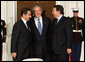 President George W. Bush offers a warm welcome to President of France Nicolas Sarkozy, left, and European Commission President Jose Manuel Barroso, right, Friday, Nov. 11, 2008, upon their arrival for a dinner to open the Summit on Financial Markets and World Economy at the White House. White House photo by Chris Greenberg