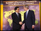 President George W. Bush welcomes the People's Republic of China President Hu Jintao to the Summit on Financial Markets and the World Economy Saturday, Nov. 15, 2008, at the National Building Museum in Washington, D.C. White House photo by Chris Greenberg