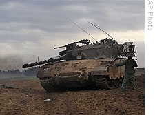 Israeli troops are seen next to the Israeli Gaza border, Thursday, Jan. 8, 2009