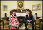 Marking International "Human Rights Day," President George W. Bush meets with Dr. Halima Bashir, a Darfur Human Rights Activist in the Oval Office of the White House. President Bush said Dr. Bashir, the author of "Tears of the Desert," "This good soul brings firsthand accounts to what life is like in Darfur. She has witnessed violence, deprivation, and she carries a message of a lot of people who want our help." White House photo by Chris Greenberg