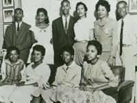 Little Rock Nine and Daisy Bates pose in living room