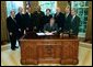 President George W. Bush signs into law, H.R. 13, the Museum and Library Services Act of 2003, in the Oval Office Thursday, Sept. 25, 2003. Pictured with the President are, from left: Congressman Ralph Regula, R-Ohio; Congressman Peter Hoekstra, R-Mich., Congressman John Boehner, R-Ohio., Education Secretary Rod Paige, Laura Bush, Dr. Robert Martin, Director of the Institute of Museum and Library Services; Senator Mike Enzi, R-Nev.; and Senator Jack Reed, D-R.I. White House photo by Tina Hager