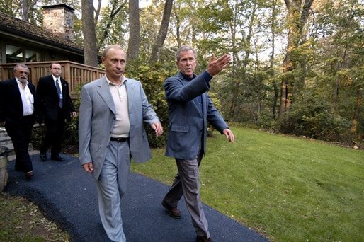 President George W. Bush escorts President Vladimir Putin of Russia after his arrival at Camp David, Friday, Sept. 26, 2003. White House photo by Eric Draper