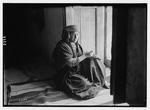 Wady Shaib Es-Salt, Amman, etc. Christian Bedouin girl of Es-Salt, sitting in doorway, sewing, LC-DIG-matpc-02737