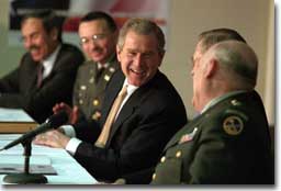 President George W. Bush shares a laugh with, from left, West Virginia Governor Robert Wise, Colonel Bill Raney, President of the Army National Guard, Secretary of Defense Donald Rumsfeld, and Lieutenant Colonel Chester Carter of the Army National Guard during a visit to the West Virginia National Guard Headquarters in Charleston, West Virginia on February 14, 2001. President Bush visited several military bases last week to reaffirm his commitment to improve living conditions for the people who serve in America's armed forces. (WHITE HOUSE PHOTO BY PAUL MORSE)