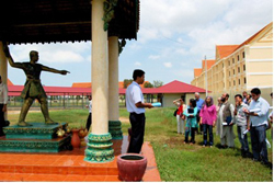 Afghan participants learn about the Extraordinary Chambers in the Courts of Cambodia before the Angkorian symbol of justice on the grounds of the Chambers.  Photo by Scott Worden