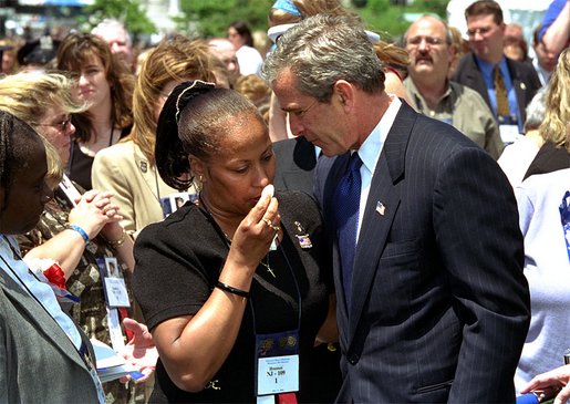 President George W. Bush embraces a woman at the 21st Annual Peace Officers' Association Memorial Service at the United States Capitol Wednesday, May 15. 