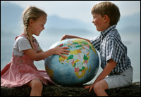 Girl and boy playing with a globe