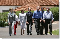 President George W. Bush and Brazil President Luiz Inacio Lula da Silva are joined by their wives, Laura Bush and Marisa Leticia da Silva, as they walk the grounds of President da Silva's Granja do Torto Saturday, Nov. 6, 2005. White House photo by Paul Morse