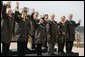 President George W. Bush and fellow APEC leaders don brown Drizabone coats as they pose for the official APEC portrait Saturday, Sept. 8, 2007, at the Sydney Opera House. White House photo by Eric Draper