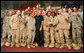 President George W. Bush greets troops on stage after his remarks at Al Asad Airbase, Al Anbar Province, Iraq, Monday, September 3, 2007. White House photo by Eric Draper