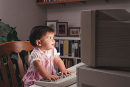 Photo of toddler playing on the computer