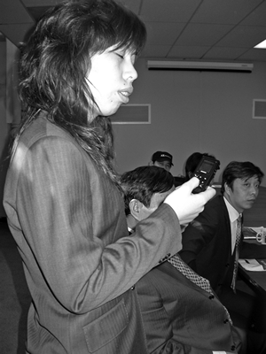 Tang Lizhen, CPB director of technology, demonstrates the Easy Speaker, a mobile-phone-sized MP3 player that converts text to speech in Cantonese, Mandarin, and English and features voice-guided controls.