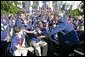 After addressing the athletes, President George W. Bush greets members of the 2004 U.S. Olympic and Paralympic Teams on the South Lawn Monday, Oct. 18, 2004. White House photo by Tina Hager