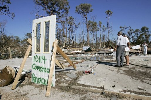 President George W. Bush stands with Al Boyd in the ruins of where Boyd's home used to be during a walking tour of neighborhoods damaged by Hurricane Ivan in Pensacola, Florida, Sunday, Sept. 19, 2004. White House photo by Eric Draper