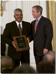 President George W. Bush stands with Thornton Stanley of Stanley Construction, Huntsville, Alabama who holds his award for the Small Business Person of the Year during a ceremony in the East Room, Tuesday, May 8. WHITE HOUSE PHOTO BY ERIC DRAPER