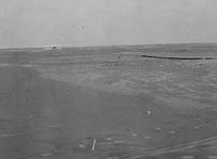 Distant view of the Wright airplane just after landing. . . . This flight, the fourth and final of December 17, 1903, was the longest: 852 feet covered in 59 seconds.