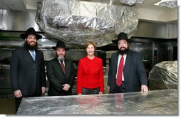 Mrs. Laura Bush poses Monday, Dec. 15, 2008, in the White House kitchen with the rabbis who supervised the kitchen's koshering for the annual Hanukkah party. From left are Rabbi Mendel Minkowitz, Rabbi Binyomin Steinmetz and Rabbi Levi Shemtov. White House photo by Joyce N. Boghosian