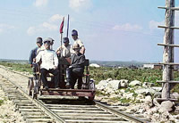 Sergei Prokudin-Gorskii, an official and four railway workers(?)riding on a railroad handcar