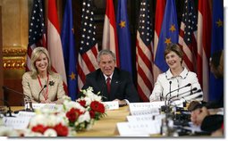 President George W. Bush and Laura Bush are joined by U.S. Ambassador to Austria Susan McCaw during a roundtable discussion Wednesday, June 21, 2006, with foreign students at the National Library in Vienna. White House photo by Eric Draper