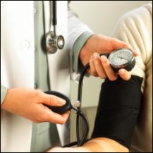 Doctor taking a patient's blood pressure.