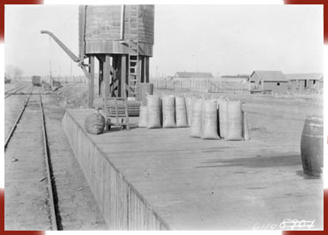Bags of popcorn on a railroad loading dock