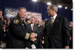 President George W. Bush greets firemen after remarks on homeland security at Northeastern Illinois Public Training Academy in Glenview, Illinois on Thursday July 22, 2004.  White House photo by Paul Morse