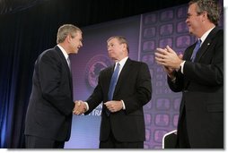 President George W. Bush is congratulated by Attorney General John Ashcroft and Florida Governor Jeb Bush after making remarks at the National Training Conference on Combating Human Trafficking in Tampa, Florida on Friday July 16, 2004.  White House photo by Paul Morse