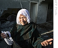 A Palestinian woman cries in front of her neighbour's home next to a school run by the United Nations which were hit by Israeli fire in the Jabalia refugee camp in the northern Gaza Strip, 07 Jan 2009