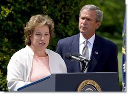 President George W. Bush listens to Betsy Rogers, 2003 National Teacher of the Year, in a ceremony in the East Garden Wednesday, April 30, 2003. Rogers is a 1st and 2nd grade teacher at Leeds Elementary School in Leeds, Ala.  White House photo by Paul Morse
