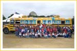 Children and Teachers in front of the Magic School Bus