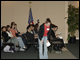 A U.S. student bows to Japanese students after a discussion about language learning.