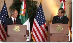 President George W. Bush and President Vicente Fox of Mexico participate in a press conference Jan. 12, 2004. "The bonds of friendship and shared values between our two nations are strong," said President Bush. "We have worked together to overcome many mutual challenges, and that work is yielding results."  White House photo by Paul Morse