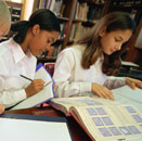 Image of two school age girls doing schoolwork