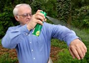 image of spraying deet on clothing