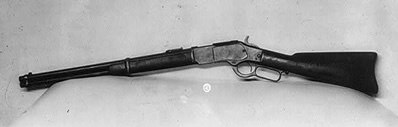 Photo of a winchester rifle. on display.