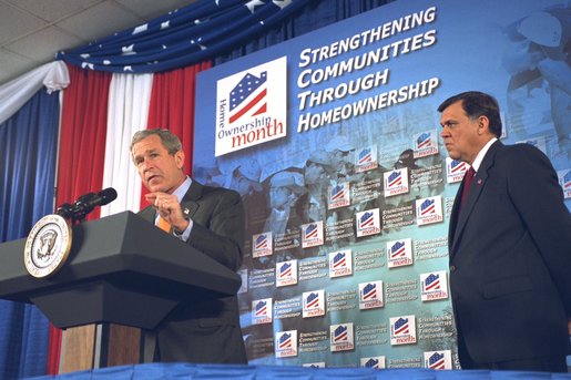 As Secretary Mel Martinez listens, President George W. Bush discusses home ownership at the Department of Housing and Urban Development Tuesday, June 18. White House photo by Tina Hager. White House photo by Tina Hager.
