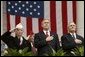 President George W. Bush stands with National Commander of the Army and Navy Union David Berger, left, and Secretary of Veterans Affairs Anthony Principi during the Veterans Day ceremonies at Arlington National Cemetery Tuesday, Nov. 11, 2003. "We observe Veterans Day on an anniversary -- not of a great battle or of the beginning of a war, but of a day when war ended and our nation was again at peace," said the President. "Ever since the Armistice of November the 11th, 1918, this has been a day to remember our debt to all who have worn the uniform of the United States." White House photo by Paul Morse.