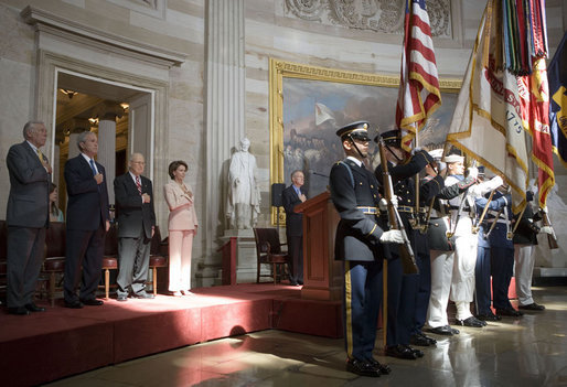 President George W. Bush stands with Dr. Norman Bourlag during the Congressional Gold Medal Ceremony honoring the doctor's efforts to combat hunger Tuesday, July 17 , 2007, at the U.S. Capitol. "Norman Borlaug's life has taken him from laboratories in America and Mexico to dusty villages throughout the developing world," said the President in his remarks. White House photo by Chris Greenberg