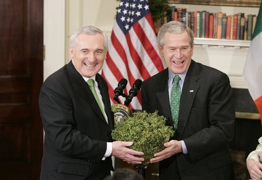 President George W. Bush accepts a bowl of shamrocks from Irish Prime Minister Bertie Ahern during a ceremony celebrating St. Patrick's Day in the Roosevelt Room Thursday, March 17, 2005. White House photo by Paul Morse