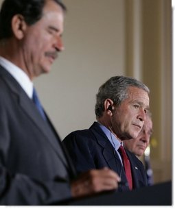 President George W. Bush participates in a March 23, 2005, joint news conference with Mexican President Vicente Fox, left, and Canadian Prime Minister Paul Martin, right, at Baylor University in Waco, Texas. "It's important for us to work to make sure our countries are safe and secure, in order that our people can live in peace, as well as our economies can grow," said President Bush.  White House photo by Krisanne Johnson