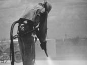 Worker using a hogh power hose